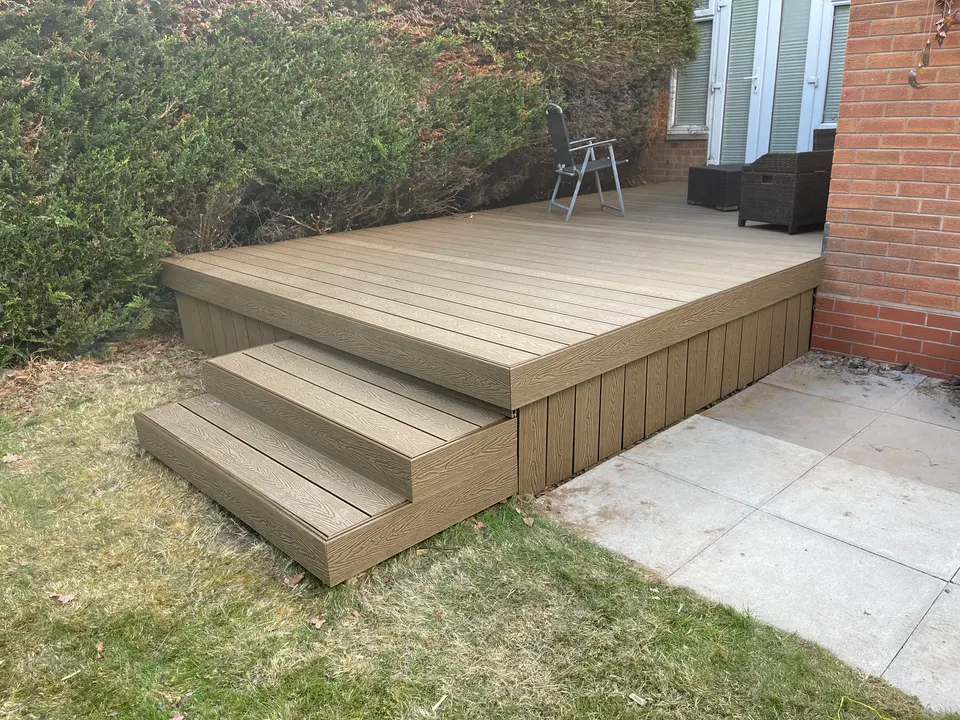 Completed raised garden deck with steps leading down to the lawn